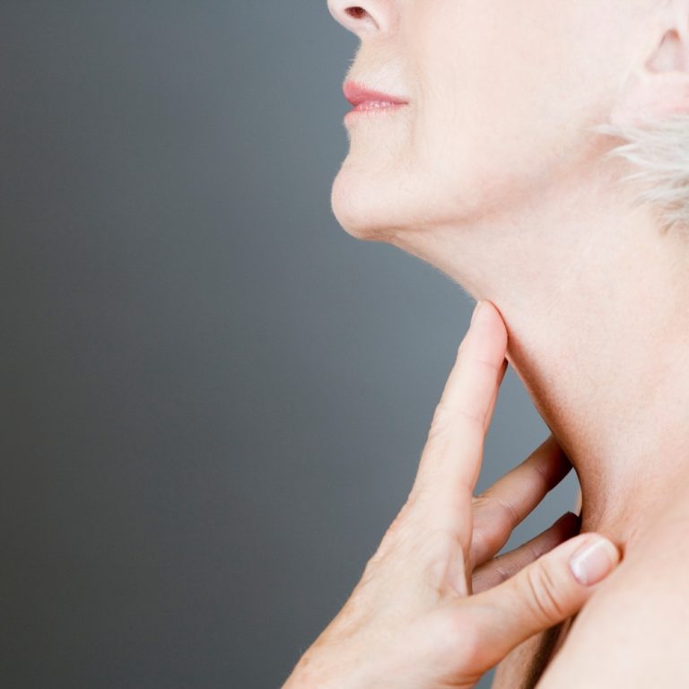 senior-woman-checking-her-thyroid-with-hand-2026-03-26-08-32-44-utc